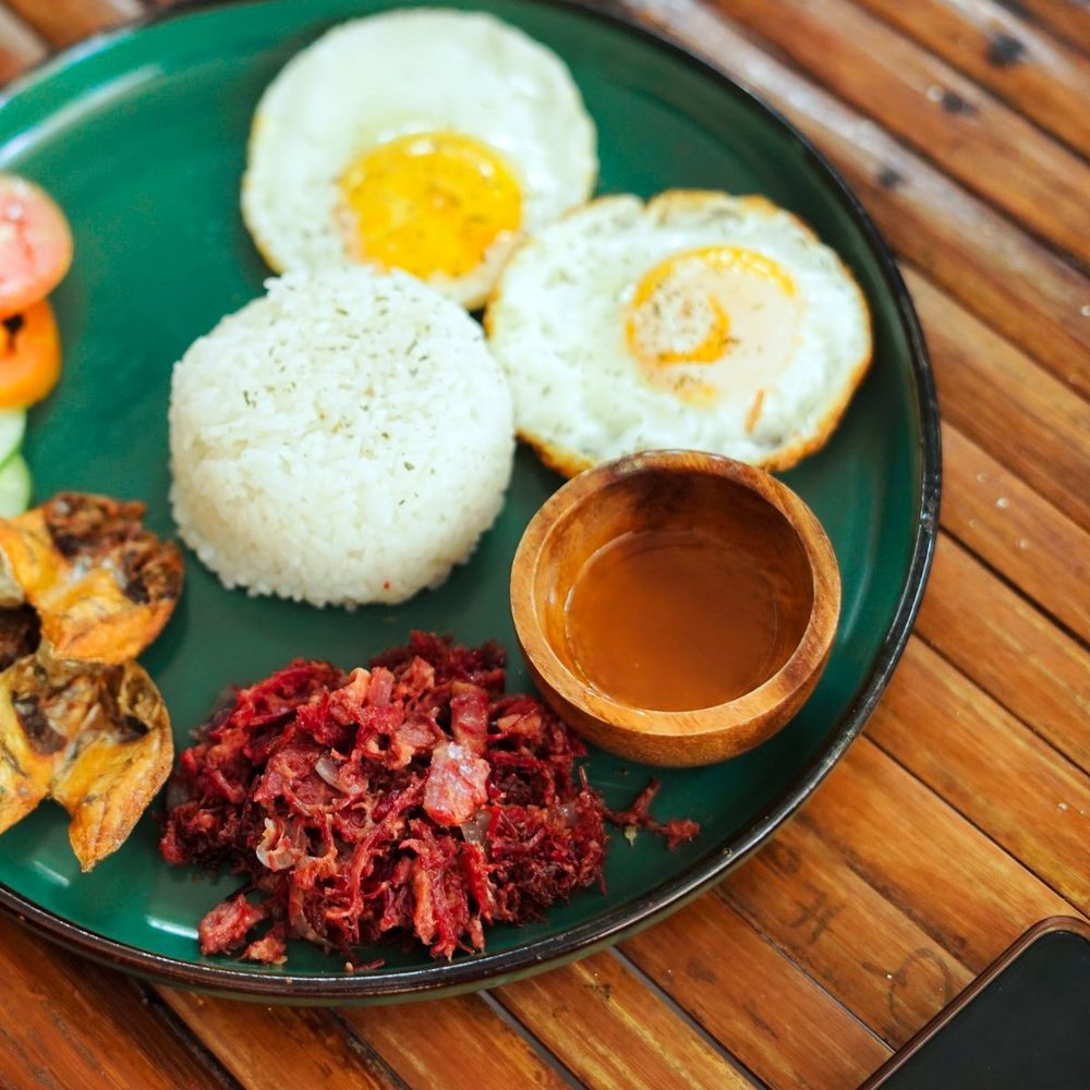 A plate of tapa, garlic rice and fried eggs