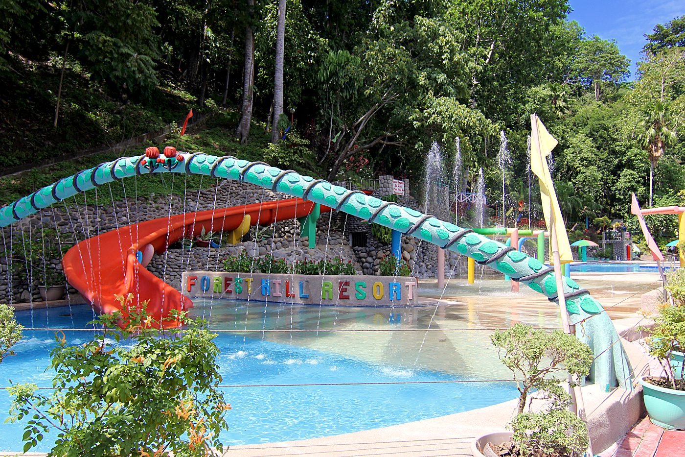 The kids' splash pad and slides under the Forest Hill Resort sign